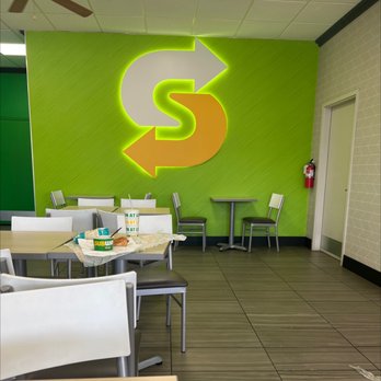 Subway - a green wall with a dollar sign painted on it - Sandwiches Near Me - Eagle River, Alaska
