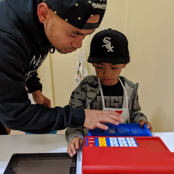 Imagination City - Little man asking Daddy to help him count Mama's change. - Indoor Playcenter Near Me - San Mateo, California Imagination City - Little man asking Daddy to help him count Mama's change. - Indoor Playcenter Near Me - San Mateo, California