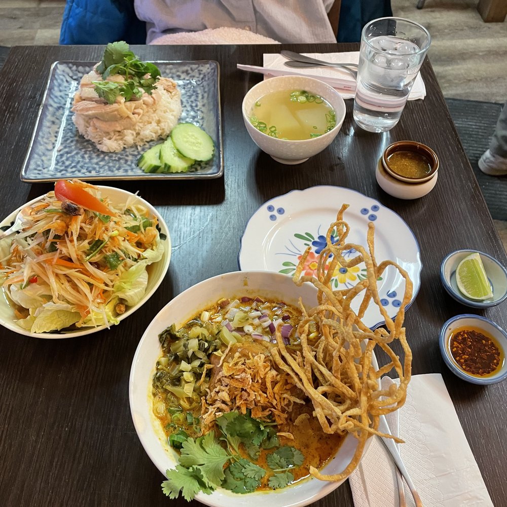 Chicken Khao Soi with spicy papaya and mango salad and ginger chicken and rice. Chicken Khao Soi with spicy papaya and mango salad and ginger chicken and rice.