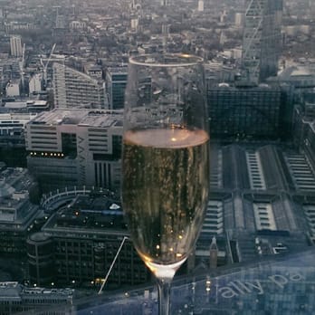 Vertigo 42 - Enjoying the sunset with a glass of Laurent Perrier Brut - Champagne Bars Near Me - London, XGL