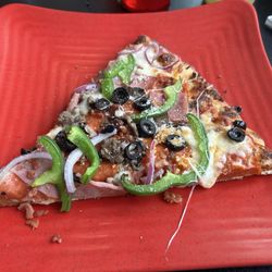 Pirate's Pizza and Wings - A slice of a loaded supreme pizza