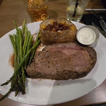 The Library Steakhouse - King cut Prime Rib with loaded baked potato and asparagus - Steakhouses Near Me - Fuquay Varina, North Carolina The Library Steakhouse - King cut Prime Rib with loaded baked potato and asparagus - Steakhouses Near Me - Fuquay Varina, North Carolina
