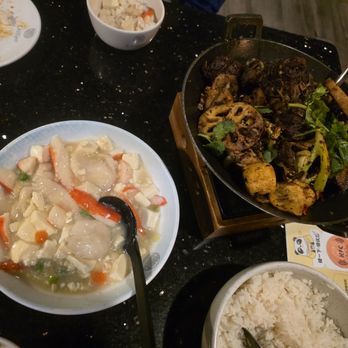 Chilispot - Lamb spine hot pot (right) and braised seafood with bean curd (left). - Szechuan Near Me - University City, Missouri