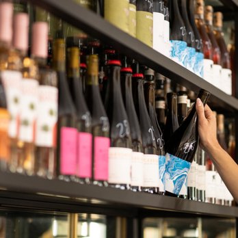 Cafe Ora - woman selecting a bottle of wine - Coffee & Tea Near Me - Los Angeles, California Cafe Ora - woman selecting a bottle of wine - Coffee & Tea Near Me - Los Angeles, California
