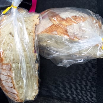 Crust - Sourdough bread. Half of the loaf is sliced for easy eating on the airplane ride home to AZ. I'm bringing butter. - Bakeries Near Me - Fenton, Michigan