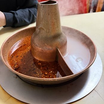 Beijing Hot Pot - Hot pot broth, spicy chicken broth on left, plain chicken broth on right - Chinese Near Me - Portland, Oregon Beijing Hot Pot - Hot pot broth, spicy chicken broth on left, plain chicken broth on right - Chinese Near Me - Portland, Oregon