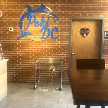 Poki DC - a table and chairs in front of a brick wall - Poke Near Me - Rockville, Maryland