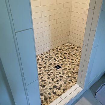 VIP Construction - Exterior shot of shower, Paul repaired/replaced several rows of the large subway tile and installed a new shower pan and pebble tile - General Contractors Near Me VIP Construction - Exterior shot of shower, Paul repaired/replaced several rows of the large subway tile and installed a new shower pan and pebble tile - General Contractors Near Me