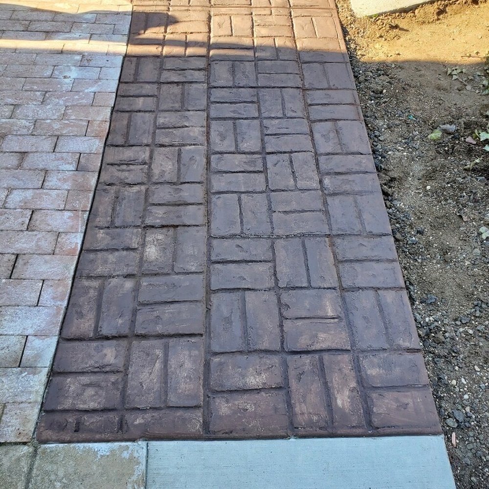 stamped and colored concrete connecting patio and existing walkway, the new concrete walkway along the back was not stamped. stamped and colored concrete connecting patio and existing walkway, the new concrete walkway along the back was not stamped.