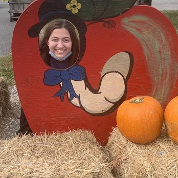 Altamont Orchards - Daughter behind pumpkin prop - Fruits & Veggies Near Me - Altamont, New York