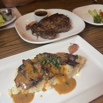 Cuts Steakhouse - Steak au poivre over top the garlic mashed potatoes. Behind is the Ribeye - Steakhouses Near Me - Atlanta, Georgia Cuts Steakhouse - Steak au poivre over top the garlic mashed potatoes. Behind is the Ribeye - Steakhouses Near Me - Atlanta, Georgia