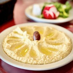 Mirage Restaurant - Excellent Hummus plate. Comes with a tiny fresh herb salad & warm pitas OuiOui :)...