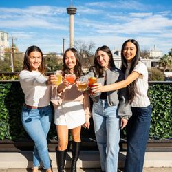Rosario's ComidaMex & Bar - Guests on our rooftop lounge enjoying a selection of cocktails with a view of The Tower of the Americas and downtown San Antonio.