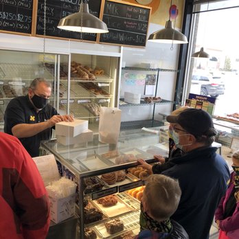 Dimo's Deli and Donuts - The gregarious Mister Dimo, namesake and owner of Dimo's Donuts, boxing up a dozen. - Delis Near Me - Ann Arbor, Michigan Dimo's Deli and Donuts - The gregarious Mister Dimo, namesake and owner of Dimo's Donuts, boxing up a dozen. - Delis Near Me - Ann Arbor, Michigan