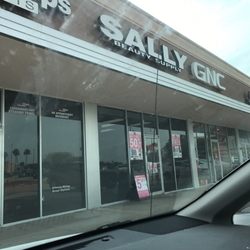 Sally Beauty - Store front. (From a bad angle) Next to GMC.