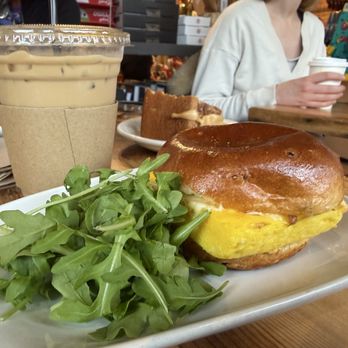 Elmendorf Baking Supplies - egg and cheese sandwich with arugula + iced latte with oat milk - Cafes Near Me - Cambridge, Massachusetts