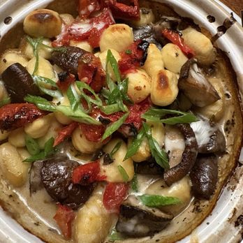 Seasons 52 - Personal fav and vegetarian - rich broth, crispy/chewy gnocchi, mushrooms/tomatoes sautéed to perfection - New American Near Me - Princeton, New Jersey
