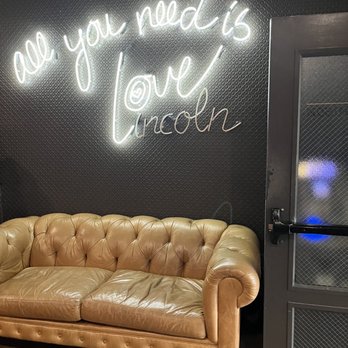 The J Parker - a couch and a neon sign - New American Near Me - Chicago, Illinois The J Parker - a couch and a neon sign - New American Near Me - Chicago, Illinois