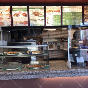 Pizza Nova - a counter with pizzas and other food items - Pizza Near Me - Toronto, Ontario