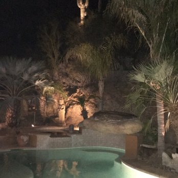 Horticultural Frontiers - a pool at night with a cactus in the background - Landscaping Near Me - Phoenix, Arizona