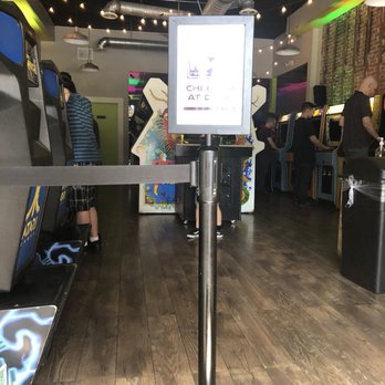 Neon Retro Arcade - There's a couch at the front to wait for friends or family during their play time. - Arcades Near Me - Pasadena, California