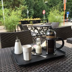Abao - Seating outside with park view - and a handmade single origin coffee