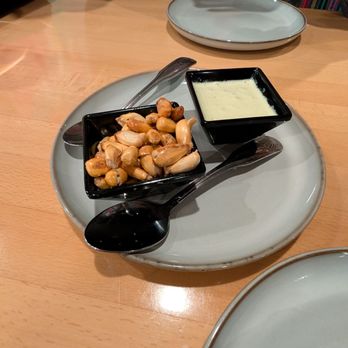 Machu Picchu - Complimentary corn nuts and green sauce - Peruvian Near Me - Somerville, Massachusetts Machu Picchu - Complimentary corn nuts and green sauce - Peruvian Near Me - Somerville, Massachusetts