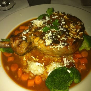 Cecco Ristorante - Pork Chop with baby carrots on a bed of rice with a manderine orange sauce - Italian Near Me - Solvang, California Cecco Ristorante - Pork Chop with baby carrots on a bed of rice with a manderine orange sauce - Italian Near Me - Solvang, California