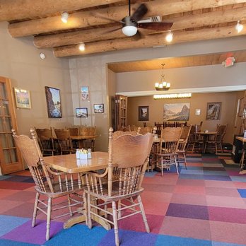 Cafe Abiquiu - One of the indoor dining spaces which is decorated with art work for sale - Mexican Near Me - Abiquiu, New Mexico