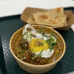 Lamb trotters with lentils and sunny side up Egg as well as a Paratha