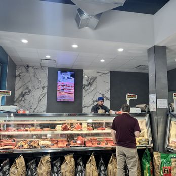 Stone Cold Meats - Cypress - a man standing in front of a display of meats - Sandwiches Near Me - Cypress, Texas Stone Cold Meats - Cypress - a man standing in front of a display of meats - Sandwiches Near Me - Cypress, Texas