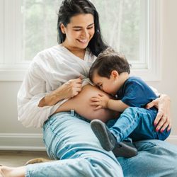 Michelle Bordenkircher Photography - Toddler boy kisses mom's belly during their Louisville in-home maternity session.