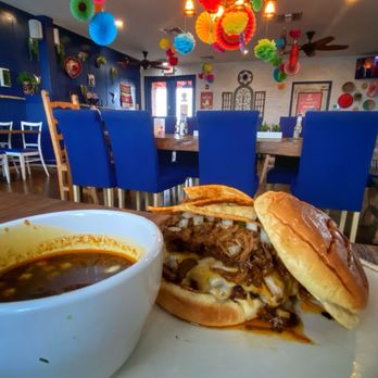 Mad Beach Cantina - "Birria Burger"   w/melted mozzarella cheese, birria onions, tortilla strips, chipotle lime aioli. Cup of rich, flavorful consommé dip. - Mexican Near Me - Madeira Beach, Florida