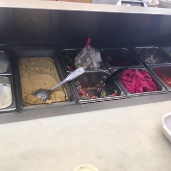 Aljibani Halal Market - There side dishes: Garlic sauce; hummus; cucumber salad (mild & spicy) cucumber yogurt; turnips; lettuce;tomato & onions - Grocery Near Me - Diamond Bar, California