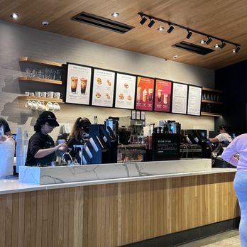 Starbucks - a woman standing in front of a counter - Coffee & Tea Near Me - Newport News, Virginia Starbucks - a woman standing in front of a counter - Coffee & Tea Near Me - Newport News, Virginia