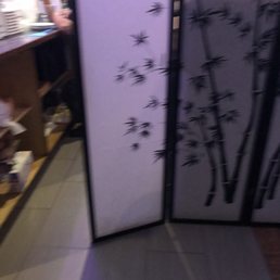 Sushi chief clipping his nails behind the bar.