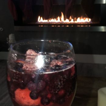 Blodgett's Cleaners - Glass of wine by lit fireplace. Cheers to Debbie and her team! - Chimney Sweeps Near Me
