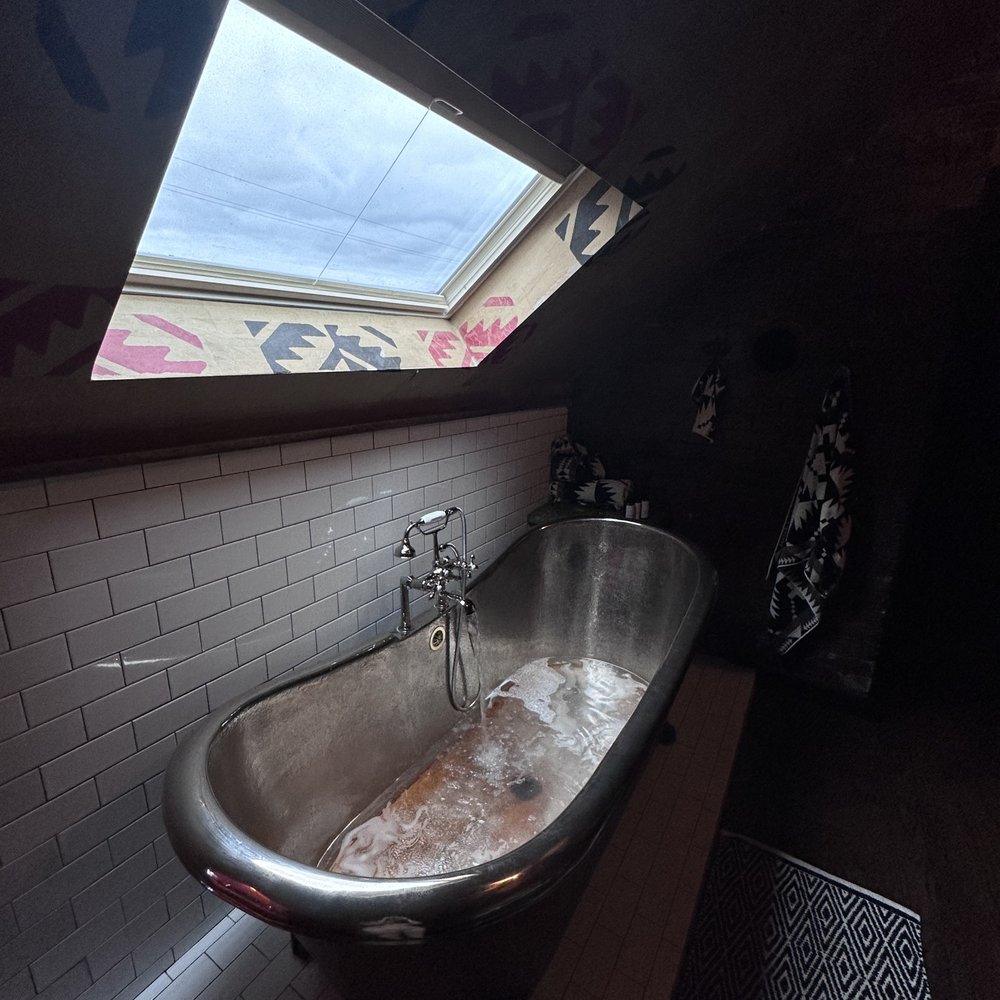 Urban Cowboy - a bathtub in a bathroom with a skylight - Bed & Breakfast Near Me - Nashville, Tennessee Urban Cowboy - a bathtub in a bathroom with a skylight - Bed & Breakfast Near Me - Nashville, Tennessee