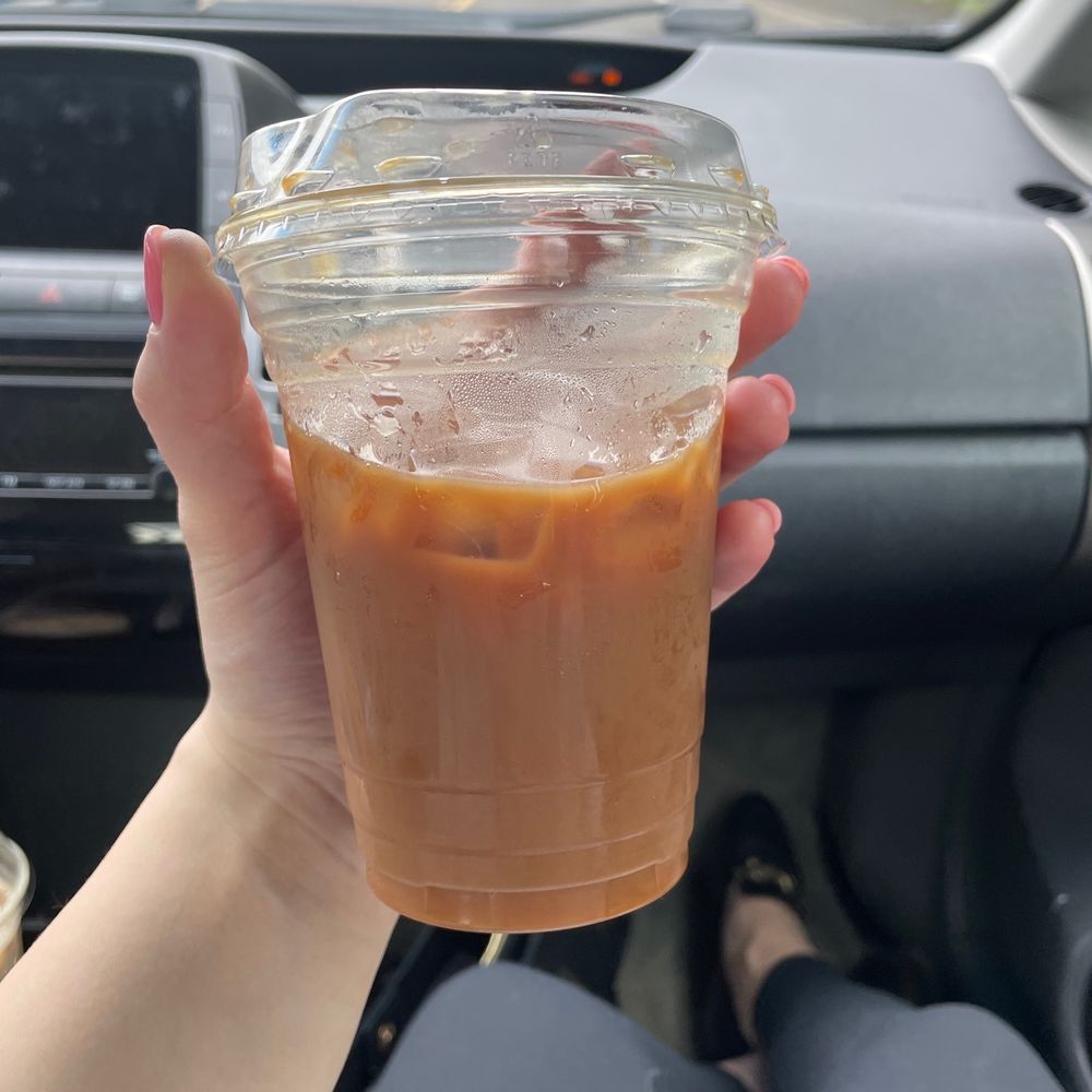 a hand holding a cup of coffee a hand holding a cup of coffee