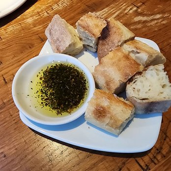 California Pizza Kitchen - Delicious olive oil with herbs and crusty French bread - Pizza Near Me - Studio City, California California Pizza Kitchen - Delicious olive oil with herbs and crusty French bread - Pizza Near Me - Studio City, California