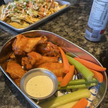 Topgolf - Buffalo wings Nachos with chicken fingers - New American Near Me - Oxon Hill, Maryland Topgolf - Buffalo wings Nachos with chicken fingers - New American Near Me - Oxon Hill, Maryland