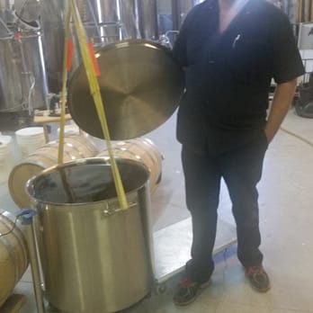 Outlaw Distillery - Kirk with a pot of Bourbon ready to be bottled - Distilleries Near Me - Midvale, Utah