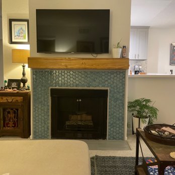 Built Well Restoration & Construction - Fireplace after. We added tile to the hearth to make it to code and updated the surround and mantle - Damage Restoration Near Me