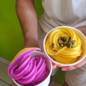 Natural FruttiBerri - a person holding two bowls of fruit - Ice Cream & Frozen Yogurt Near Me - Watertown, Massachusetts