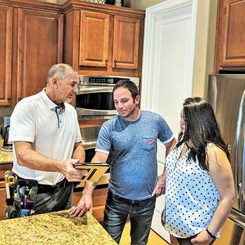 Coakley Construction and Inspection Services - two men and a woman in a kitchen - Home Inspectors Near Me Coakley Construction and Inspection Services - two men and a woman in a kitchen - Home Inspectors Near Me