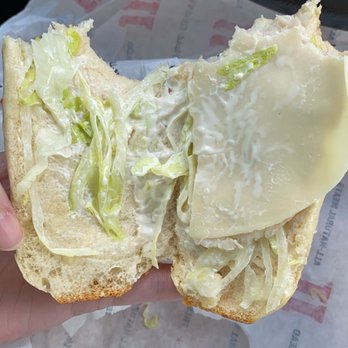 Jimmy John's - a hand holding a sandwich with cheese and lettuce - Sandwiches Near Me - Cincinnati, Ohio Jimmy John's - a hand holding a sandwich with cheese and lettuce - Sandwiches Near Me - Cincinnati, Ohio