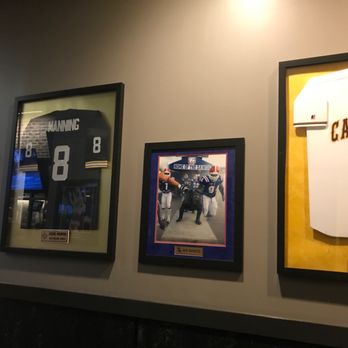 Buffalo Wild Wings - a number of framed sports memorabilia - Sports Bars Near Me - Bossier City, Louisiana