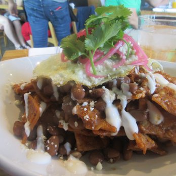 Trust - CHILAQUILES ROJOS 2 eggs, crema, cotija, pinto beans, guacamole, pickled onions, cilantro TRUST San Diego - New American Near Me - San Diego, California Trust - CHILAQUILES ROJOS 2 eggs, crema, cotija, pinto beans, guacamole, pickled onions, cilantro TRUST San Diego - New American Near Me - San Diego, California
