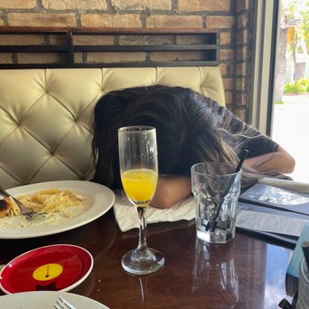 Rosinella - knocked out after eating the Penne Gorgonzola and drinking the mimosa - Italian Near Me - Miami Beach, Florida