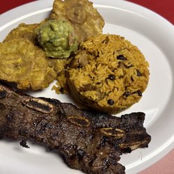 El Mata Munchies - Costilla de Res with Arroz de gandules and Tostones topped with Guac